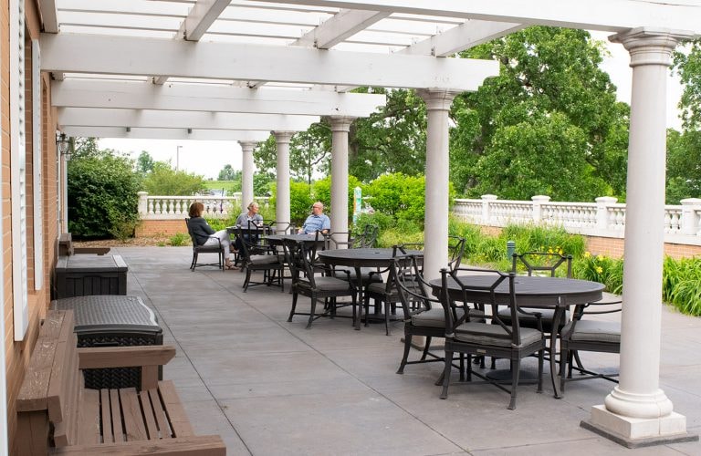 Fisher House patio with pergola and guests